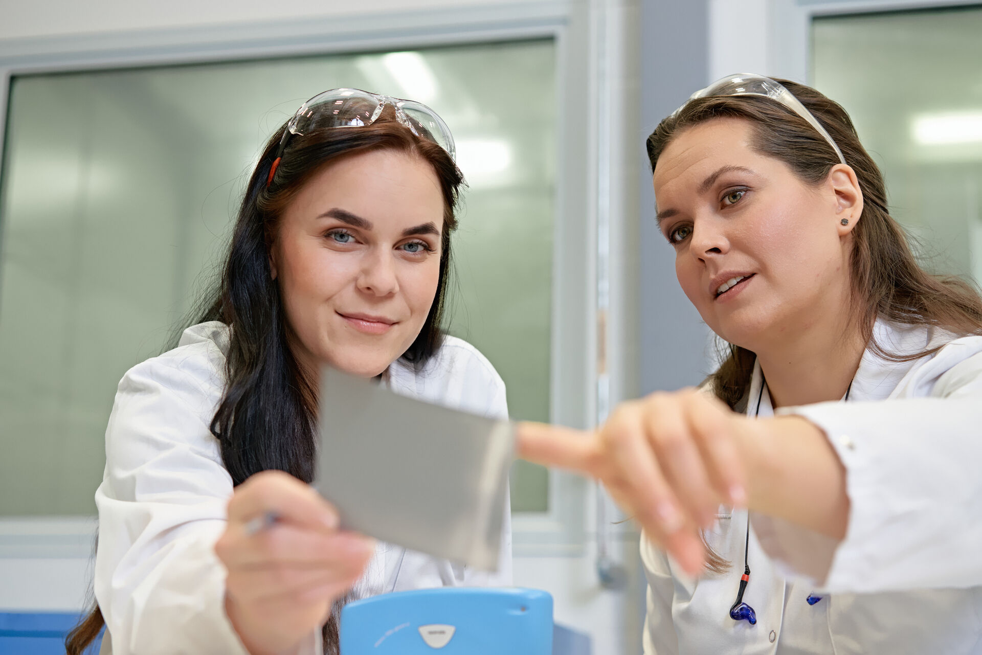 Two laboratory workers talking - quality check in laboratory close (1).jpg